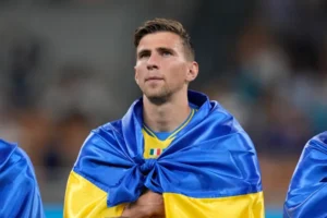 Illia Zabarnyi draped in Ukraine’s flag before Euro 2024 qualifier against Italy in 2023.